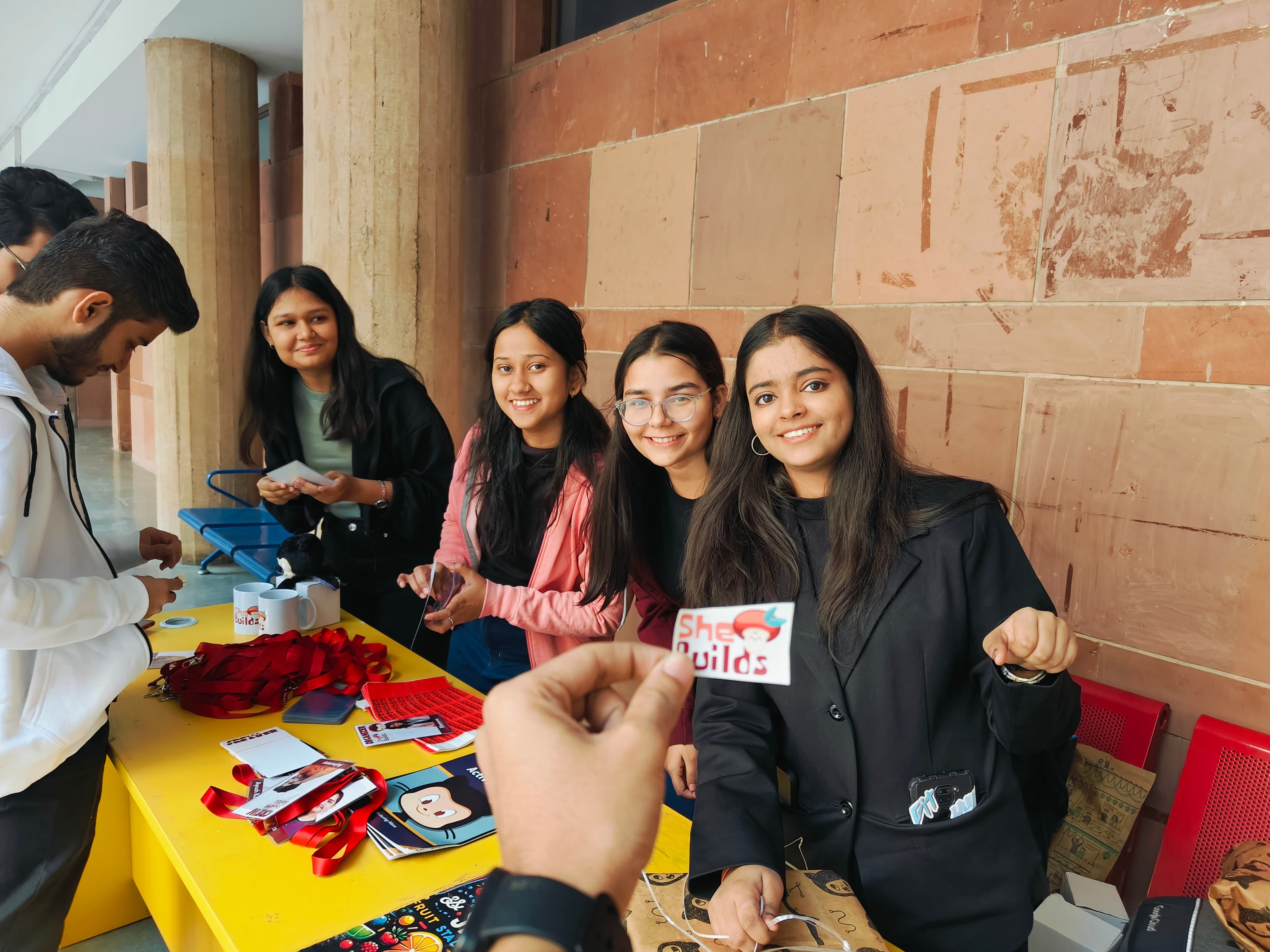 SheBuilds team welcoming attendees at an event registration table in Delhi